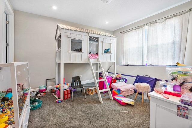 carpeted bedroom featuring a textured ceiling