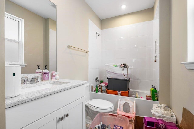 full bathroom with vanity, toilet, and tiled shower / bath combo