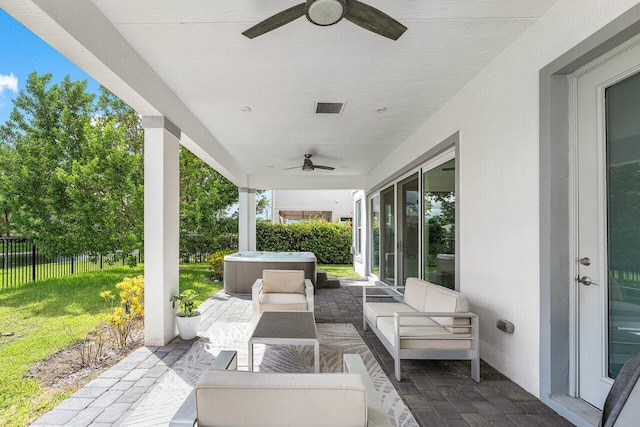 view of patio / terrace with an outdoor hangout area, ceiling fan, and a hot tub