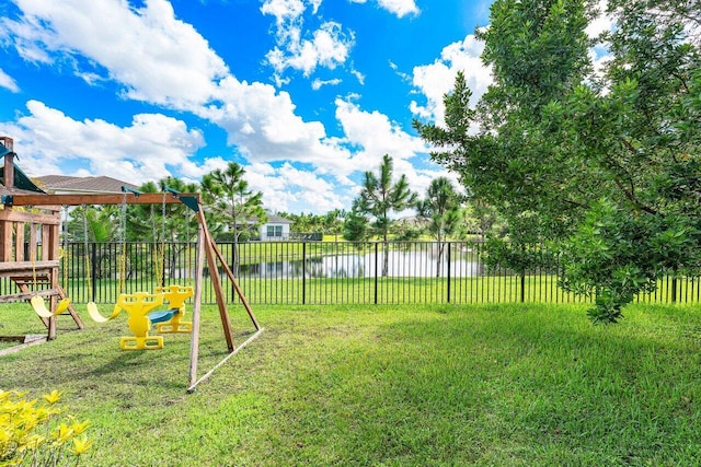 view of yard featuring a water view and a playground