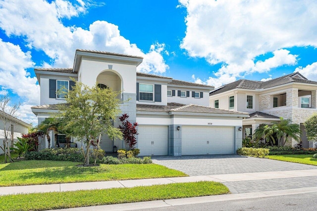 mediterranean / spanish-style house with a garage and a front yard