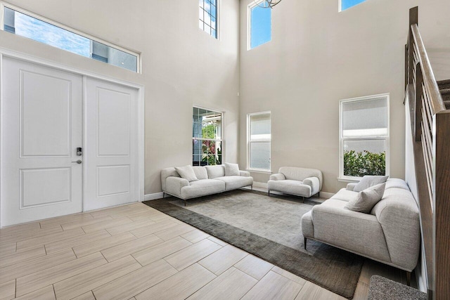 living room featuring a wealth of natural light and a towering ceiling