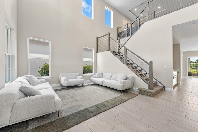 living room with a towering ceiling and a wealth of natural light