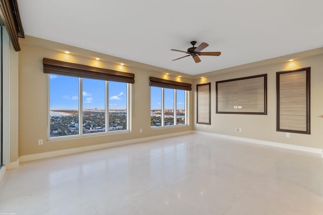 empty room featuring plenty of natural light and ceiling fan