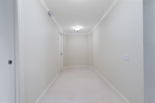 hallway with crown molding and light tile patterned flooring