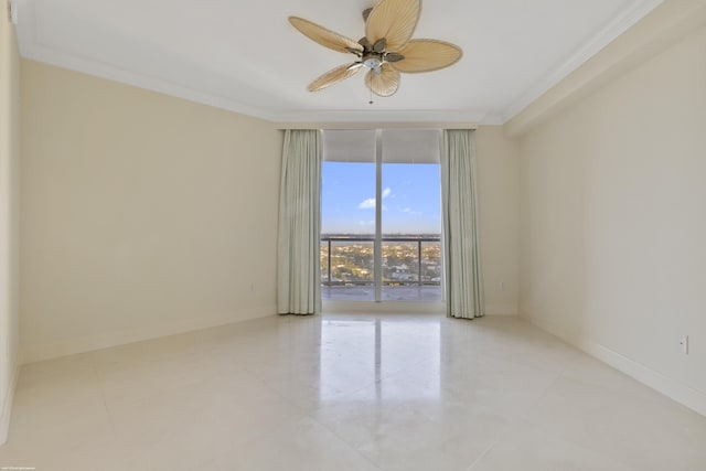 empty room with ceiling fan, expansive windows, and ornamental molding