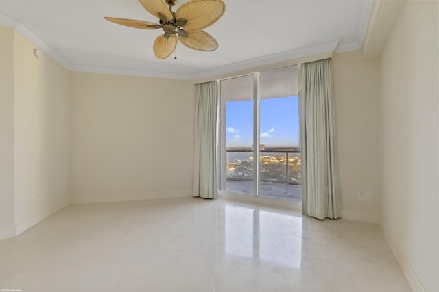 spare room featuring ceiling fan and crown molding