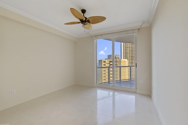 empty room featuring ceiling fan and crown molding