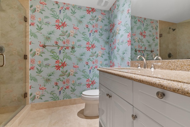 bathroom with tile patterned flooring, vanity, toilet, and a shower with shower door