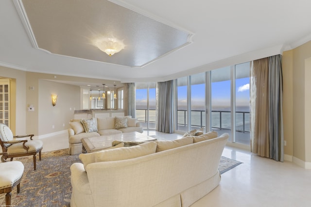 living room with crown molding, a water view, and a wall of windows