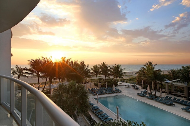 pool at dusk with a water view