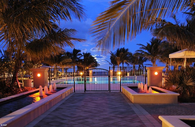 view of pool at dusk