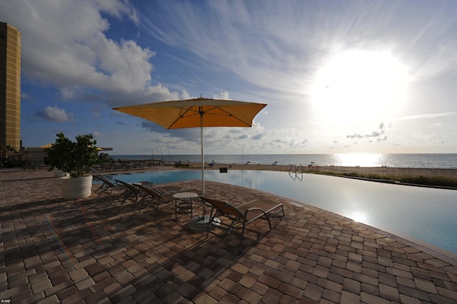 view of swimming pool with a water view