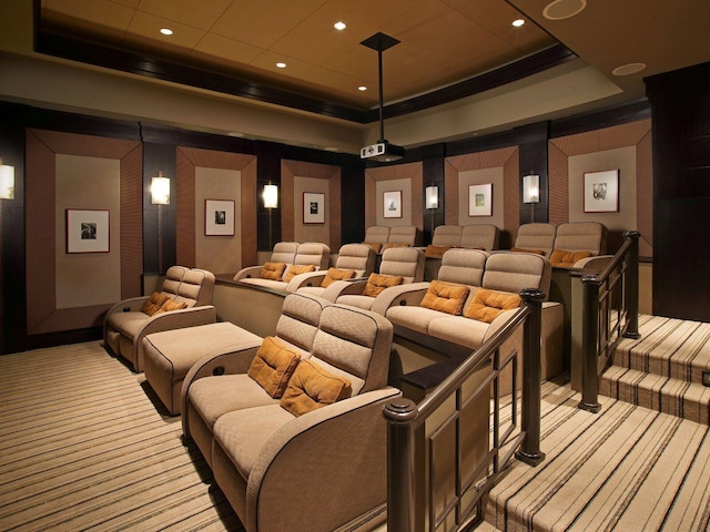 carpeted home theater room with a raised ceiling