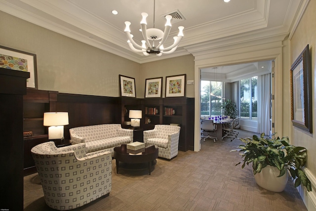 sitting room with crown molding, carpet floors, and an inviting chandelier