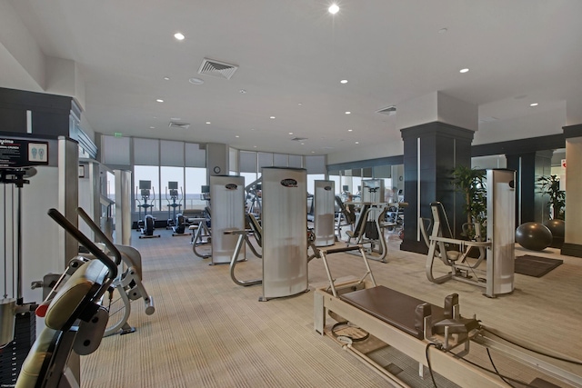 workout area with light carpet and expansive windows