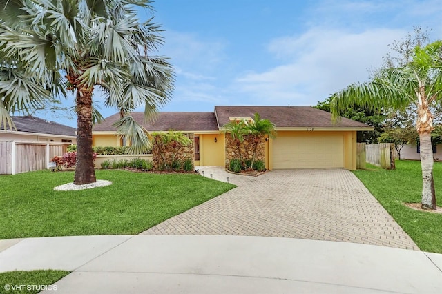 ranch-style home featuring a garage and a front lawn