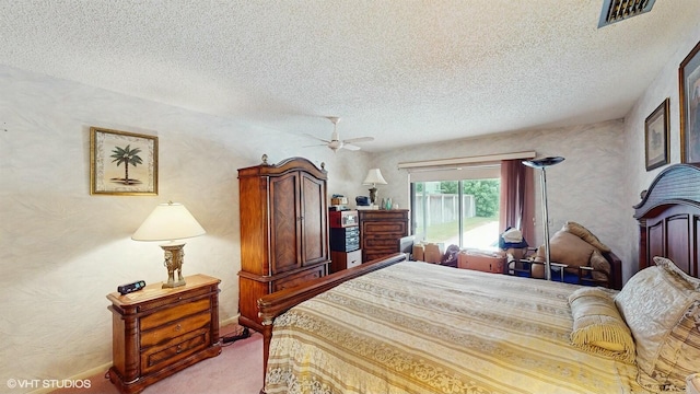 carpeted bedroom with a textured ceiling and ceiling fan