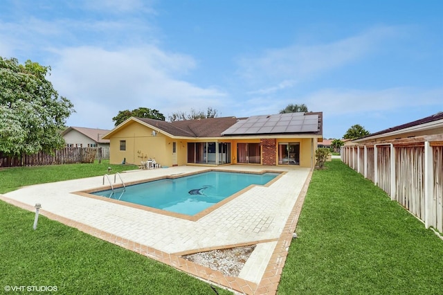 view of pool featuring a yard and a patio