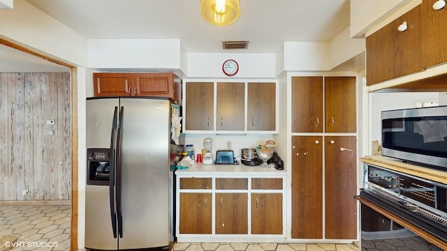 kitchen with appliances with stainless steel finishes and light tile patterned floors