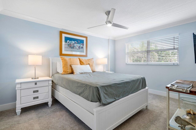 bedroom with ceiling fan, crown molding, carpet, and a textured ceiling