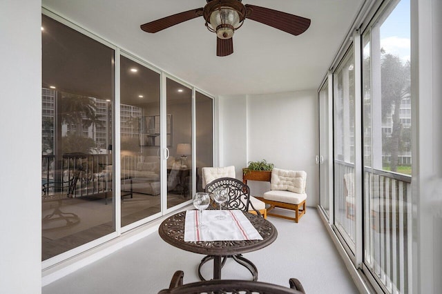 sunroom featuring ceiling fan