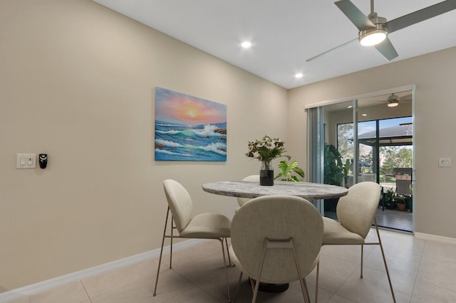 dining space with ceiling fan and light tile patterned flooring