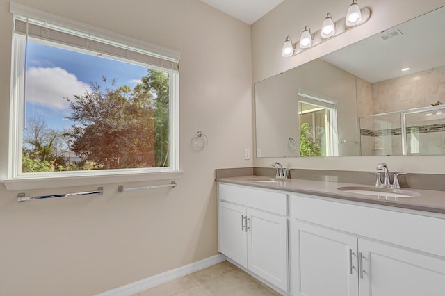 bathroom featuring tile patterned flooring, vanity, and a shower with door