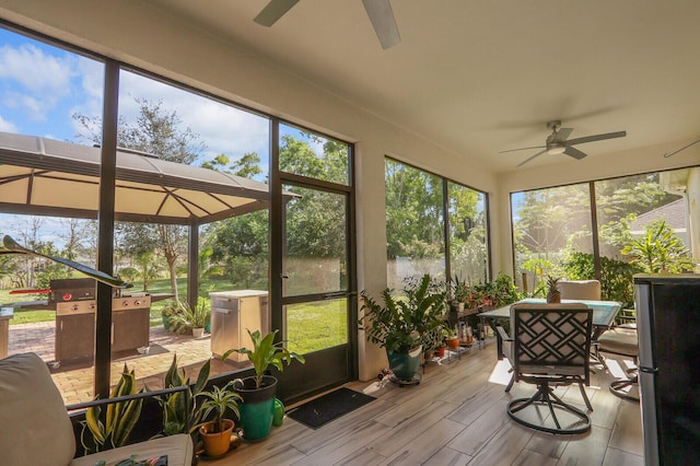 sunroom featuring plenty of natural light and ceiling fan