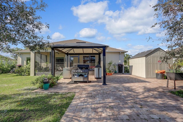 view of patio with a gazebo, a shed, and grilling area