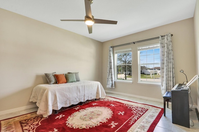 tiled bedroom featuring ceiling fan