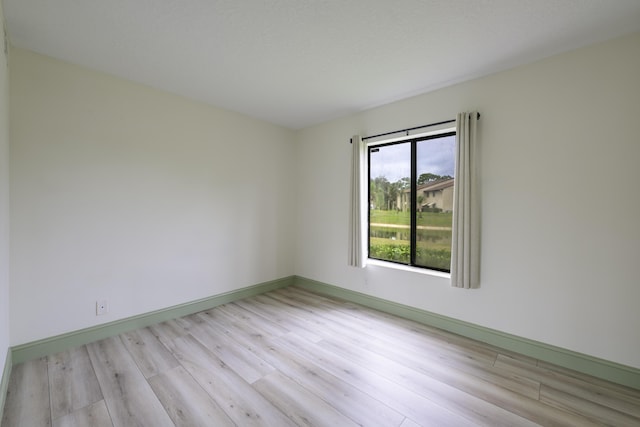 unfurnished room with light hardwood / wood-style flooring