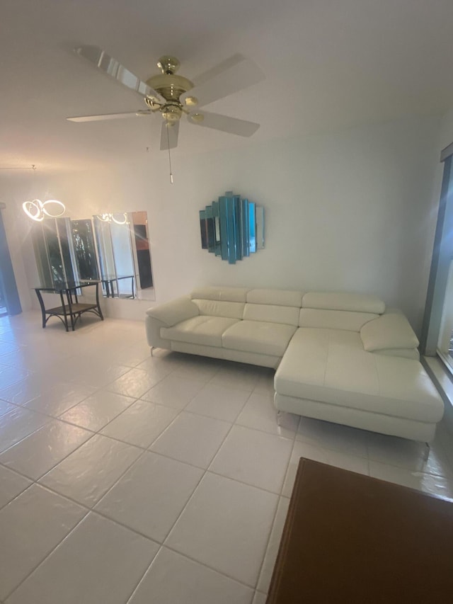 unfurnished living room with tile patterned floors and ceiling fan