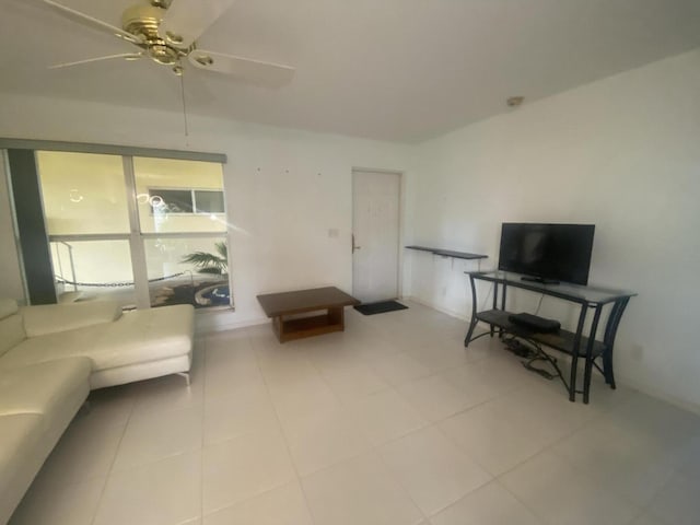 tiled living room with ceiling fan