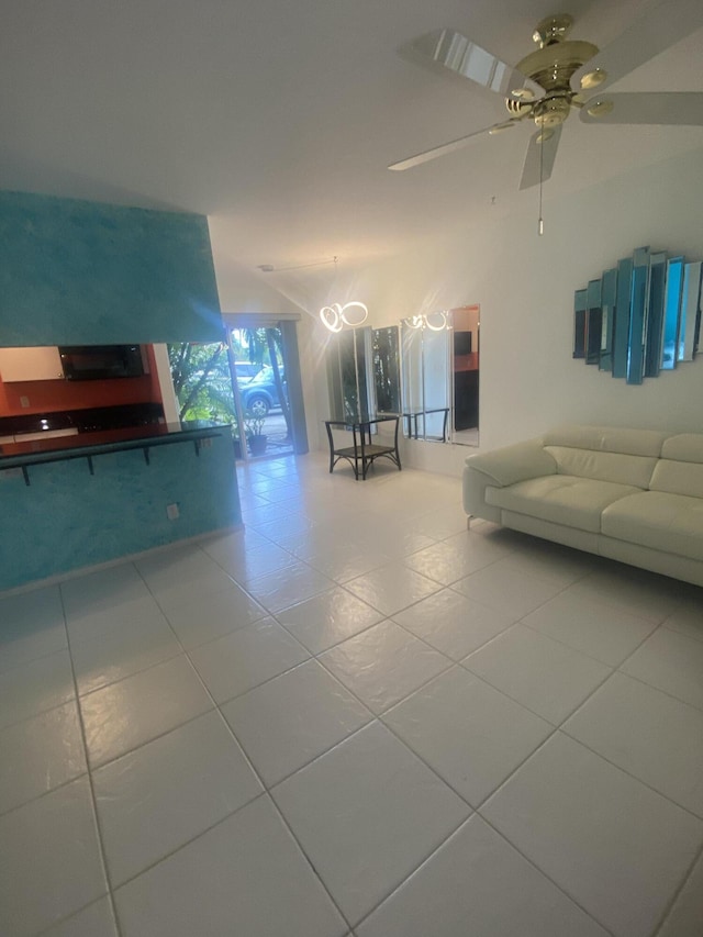 unfurnished living room with tile patterned floors and ceiling fan