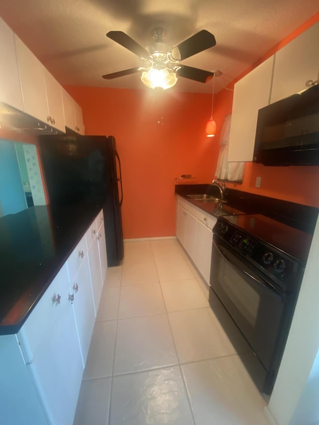 kitchen featuring hanging light fixtures, sink, light tile patterned floors, black / electric stove, and white cabinetry