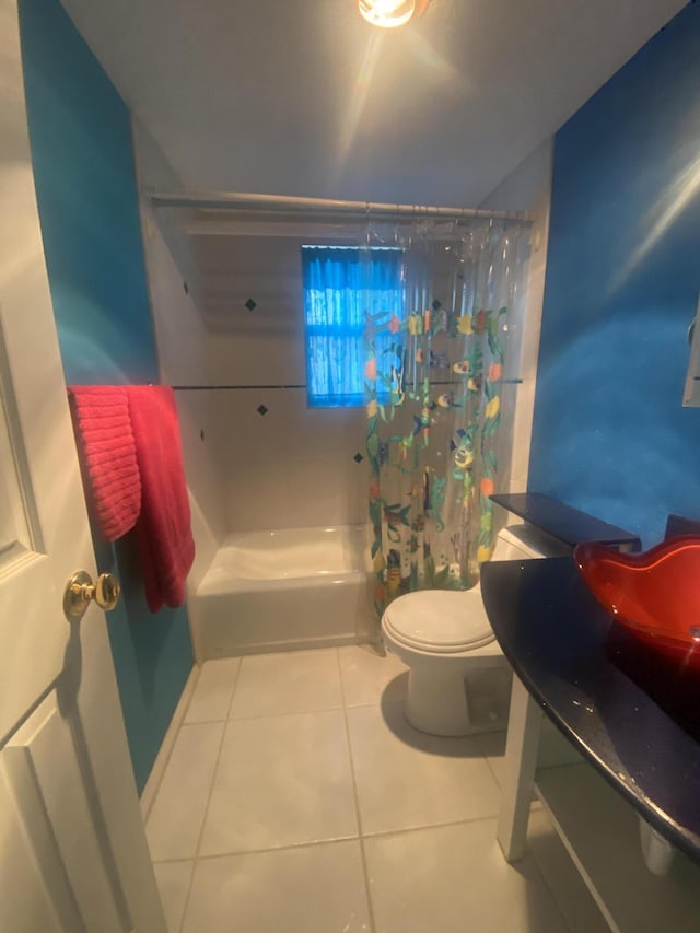 bathroom featuring tile patterned floors, shower / tub combo with curtain, and toilet