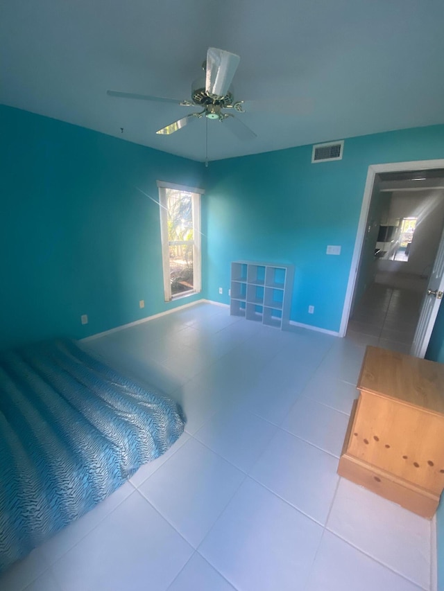 tiled bedroom with ceiling fan