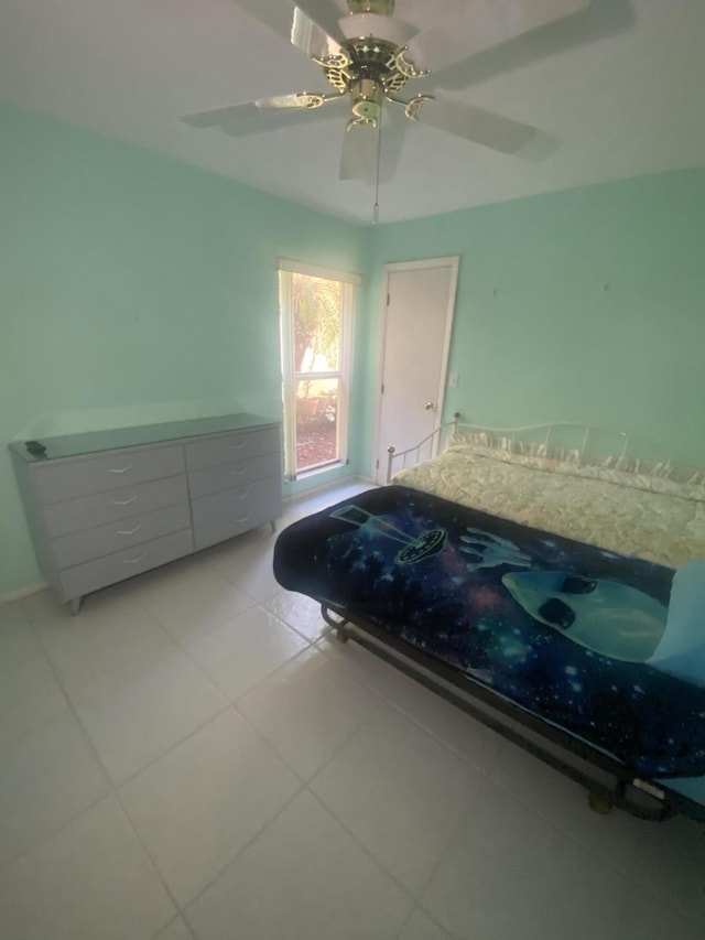 unfurnished bedroom with ceiling fan and light tile patterned floors