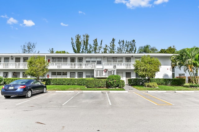 view of property featuring uncovered parking