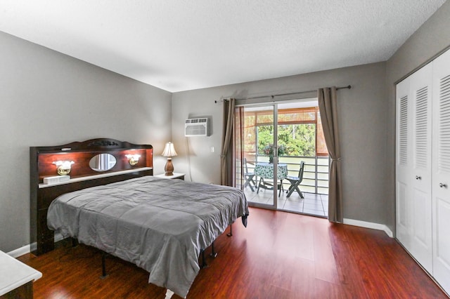 bedroom featuring access to outside, a closet, baseboards, and wood finished floors