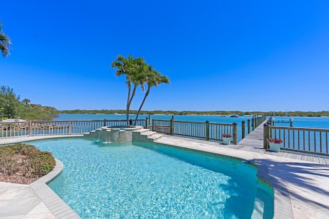 view of swimming pool with an in ground hot tub and a water view