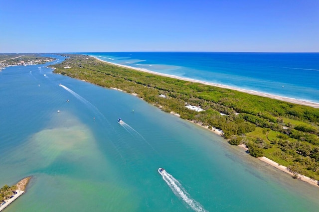 drone / aerial view featuring a water view and a view of the beach