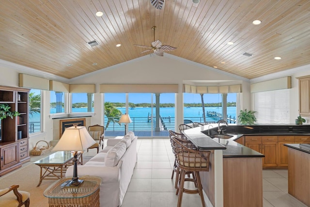 sunroom with wooden ceiling, a water view, sink, vaulted ceiling, and ceiling fan