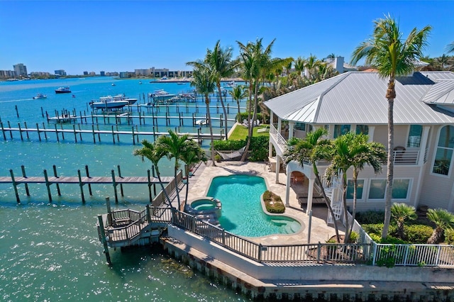 view of swimming pool featuring a dock, a water view, and a patio