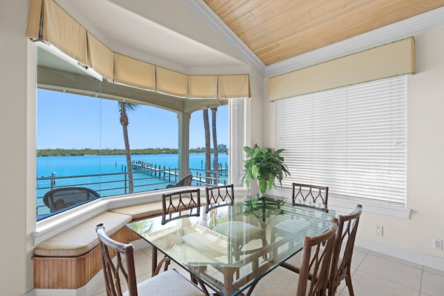 interior space with wood ceiling, crown molding, light tile patterned floors, a water view, and lofted ceiling