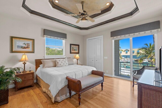 tiled living room with a water view, ornamental molding, and a textured ceiling