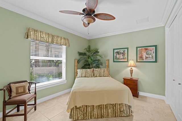 tiled bedroom featuring crown molding, ceiling fan, and a closet