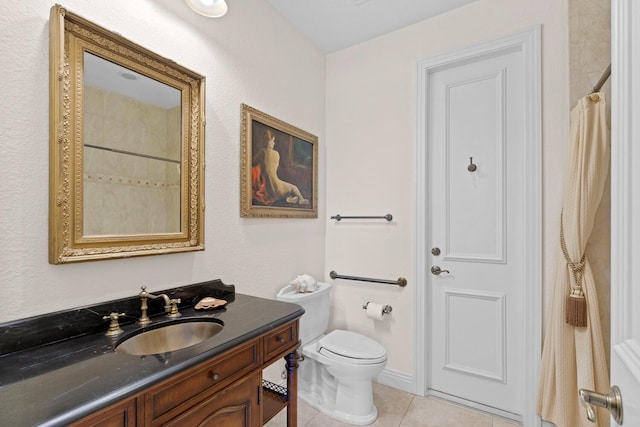 bathroom featuring vanity, tile patterned floors, and toilet