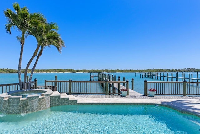 view of pool featuring an in ground hot tub, pool water feature, a dock, and a water view